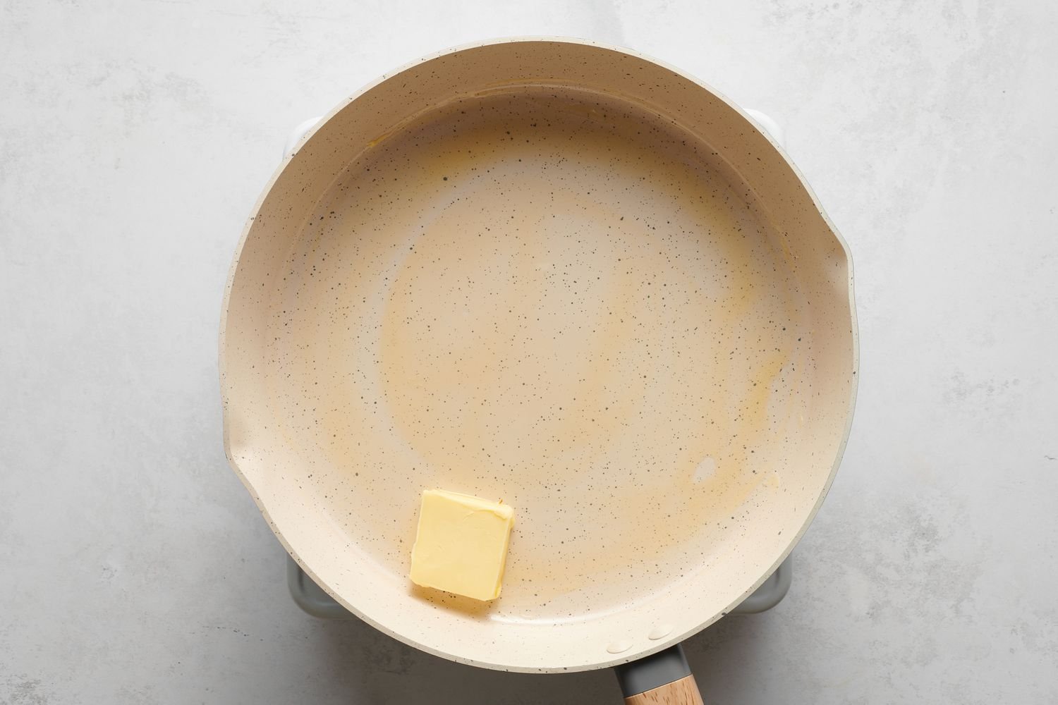 A pad of butter in a large skillet