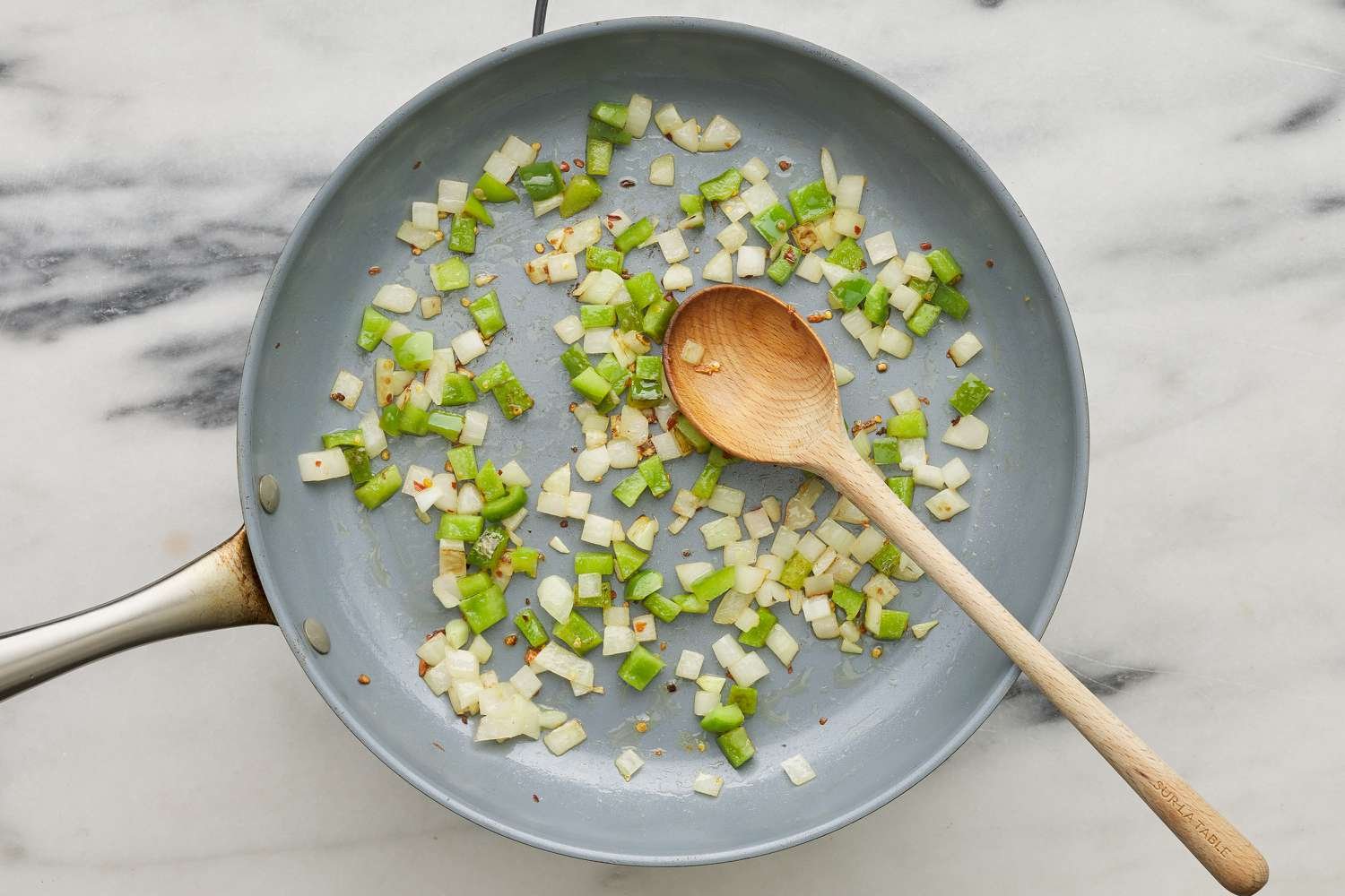 onions and green pepper being sauteed