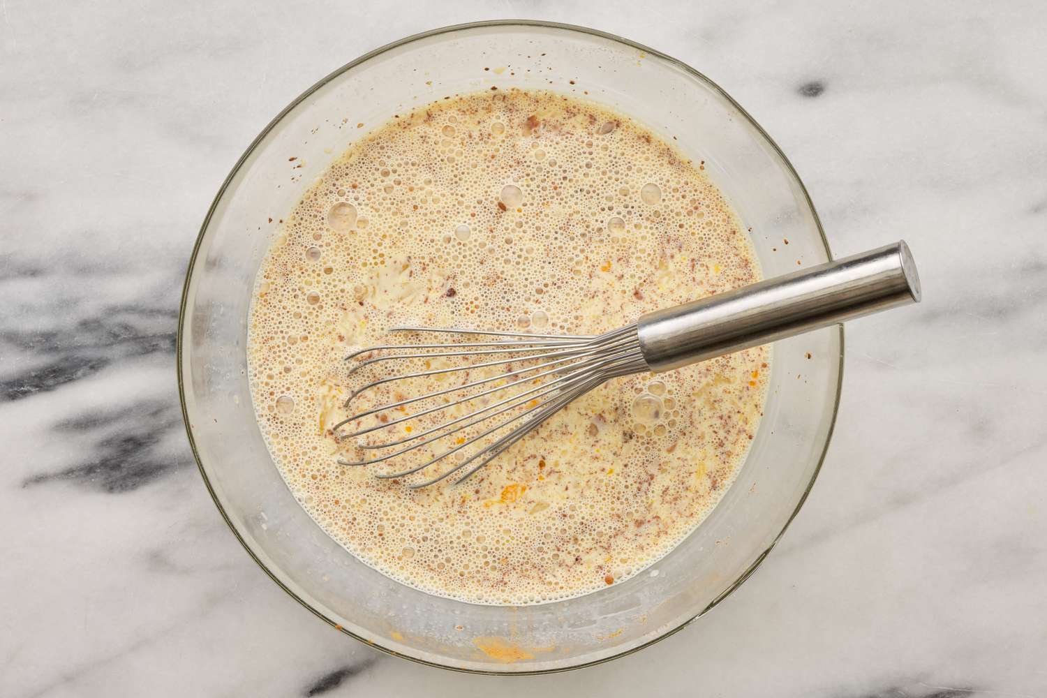 french toast casserole custard whisked together in bowl