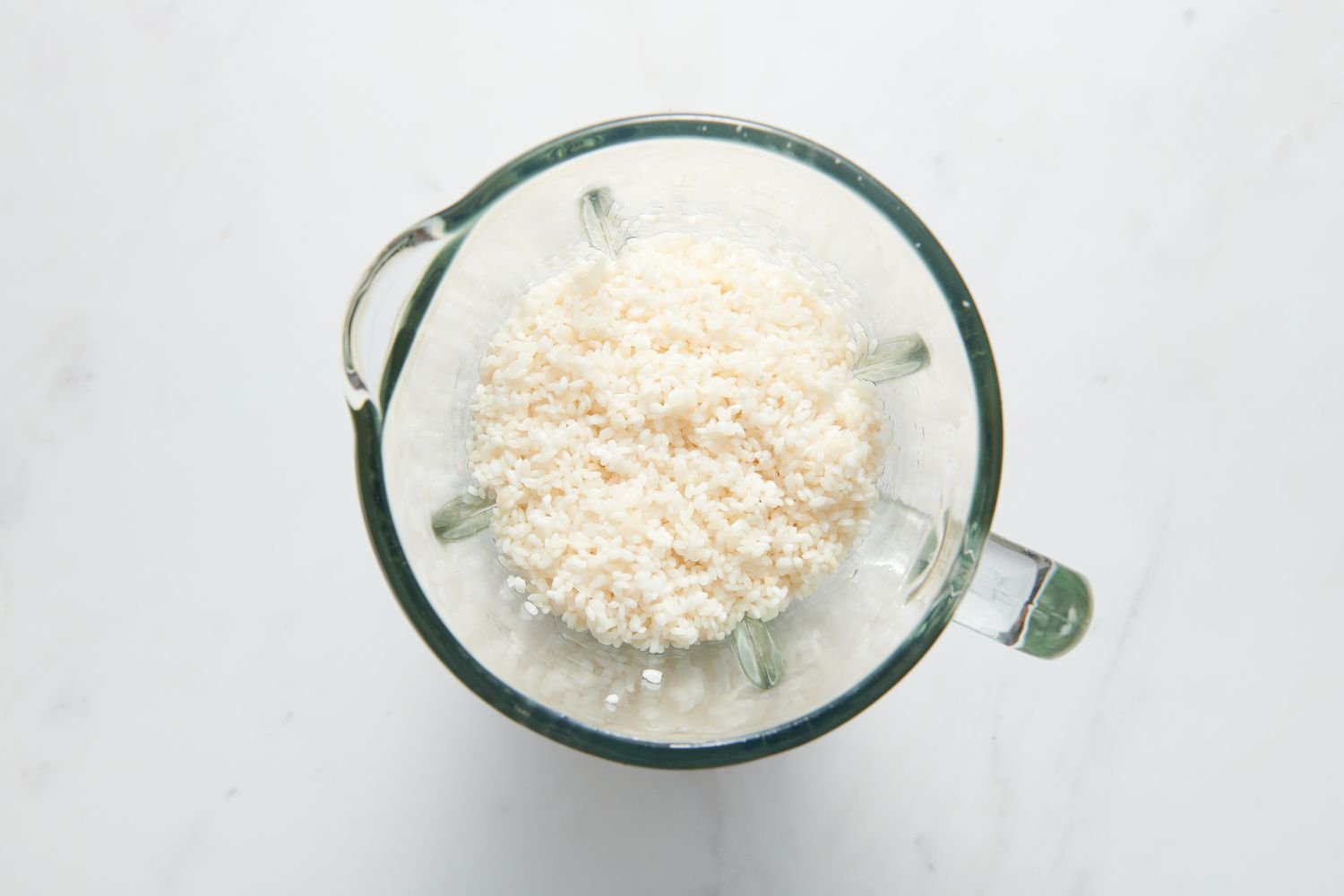 A blender pitcher with soaked Sona Masuri rice