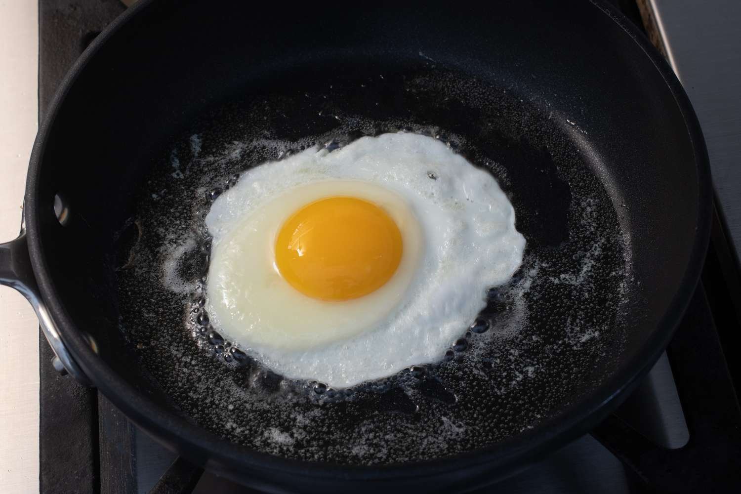 Egg with most of the white firm in the skillet