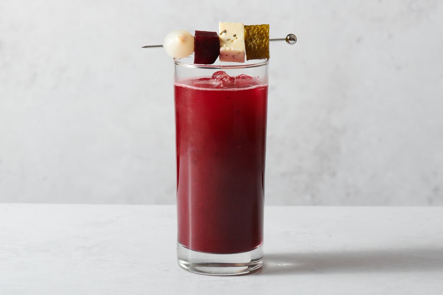 A Beet and Aquavit Bloody Mary garnished with various ingredients