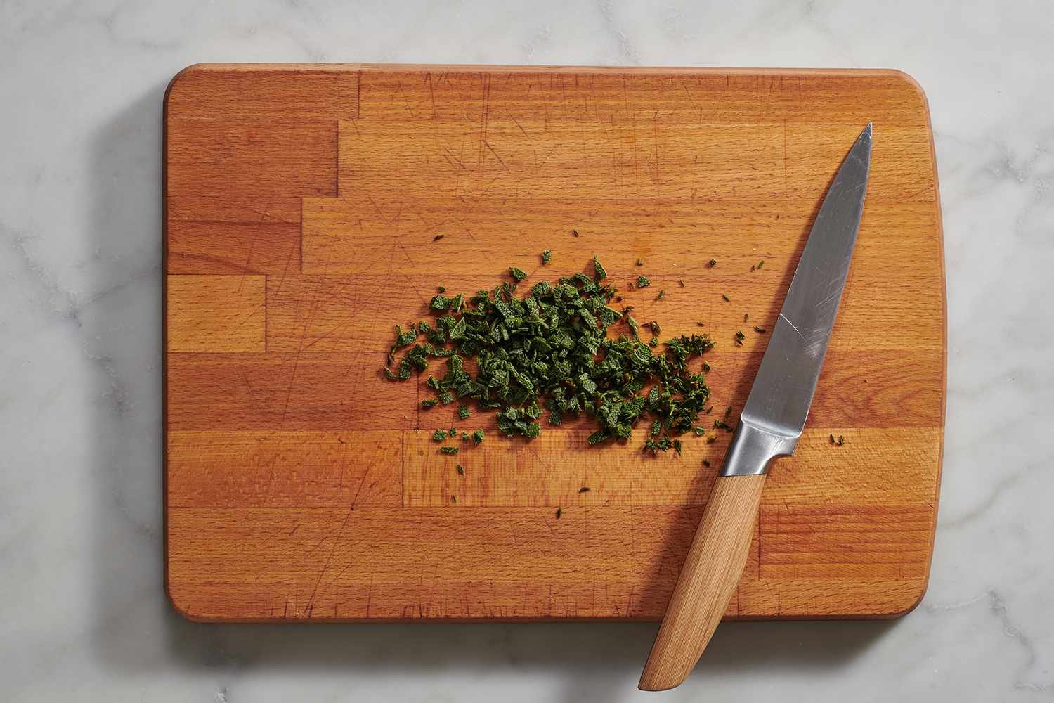 chopped sage on a cutting board