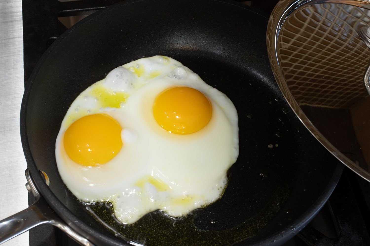Checking the eggs in the skillet.