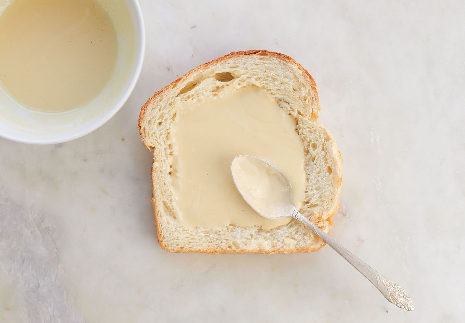 adding custard to the well of bread