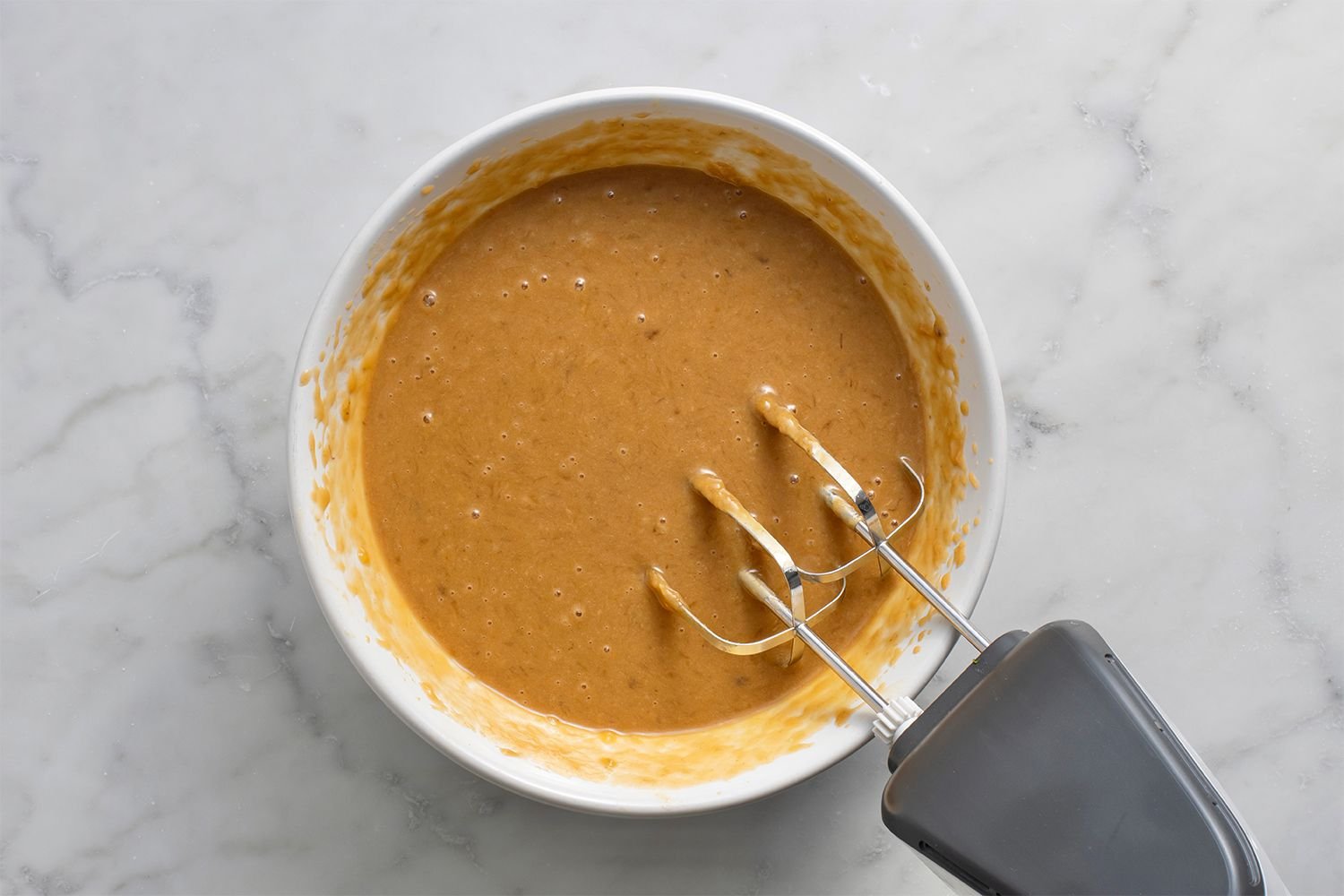 Peanut butter combined with the banana mixture in the bowl, using a hand mixer