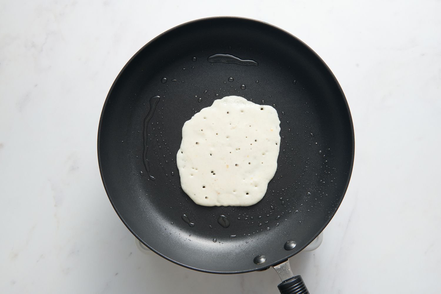 Pouring batter onto the hot skillet