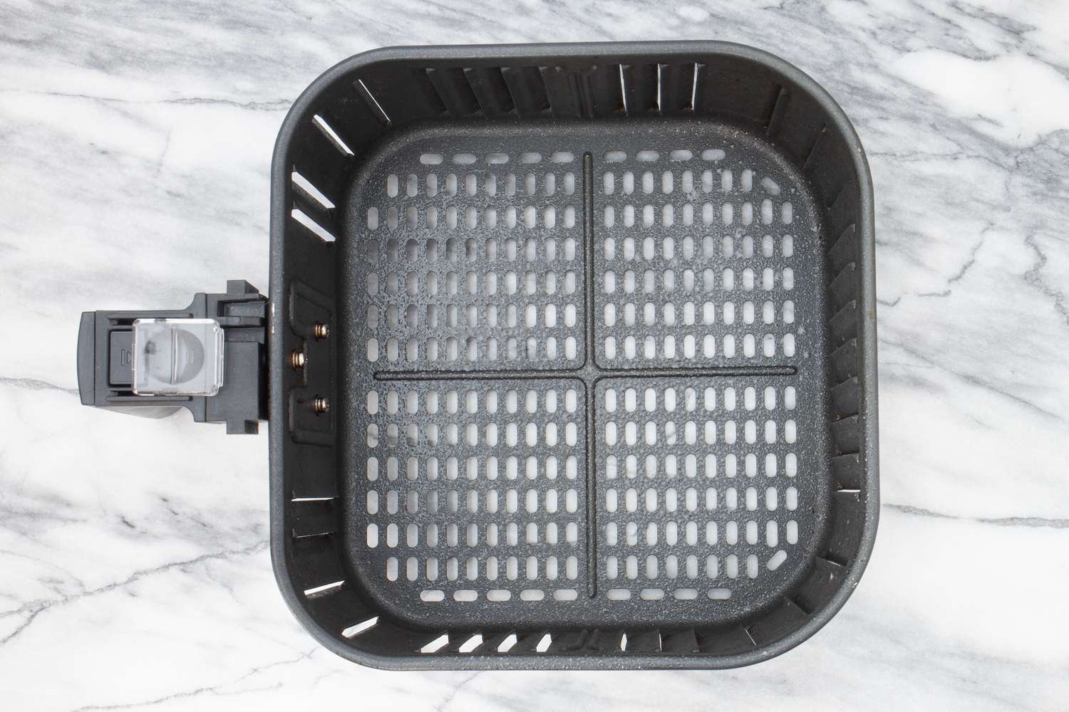air fryer basket prepared with cooking spray