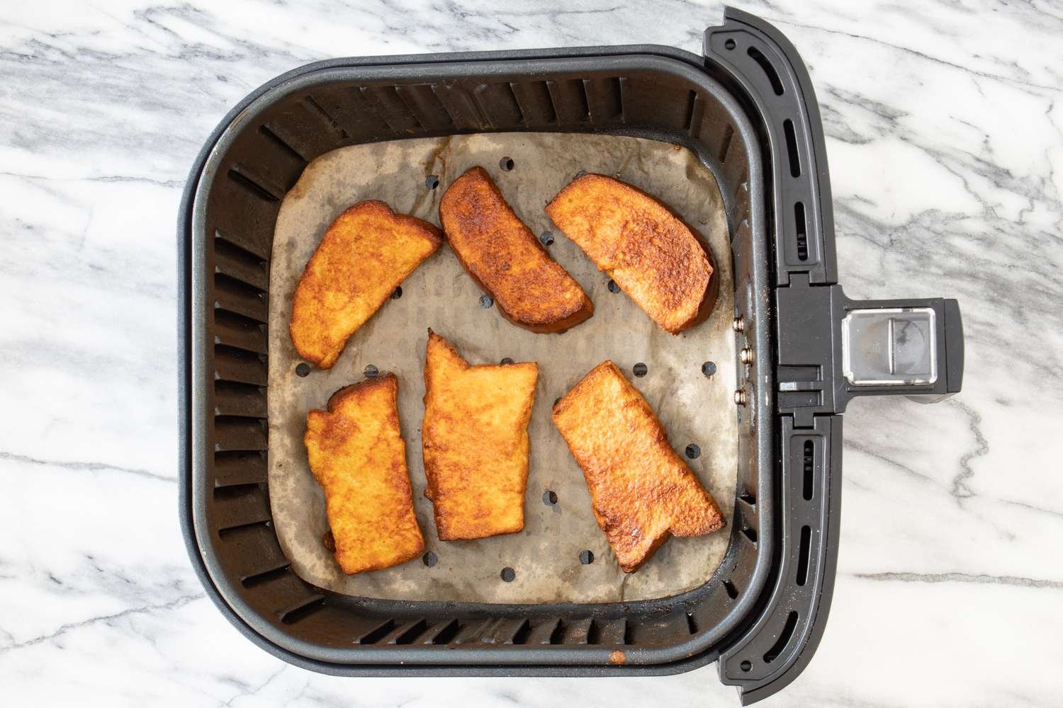 french toast sticks cooking in an air fryer