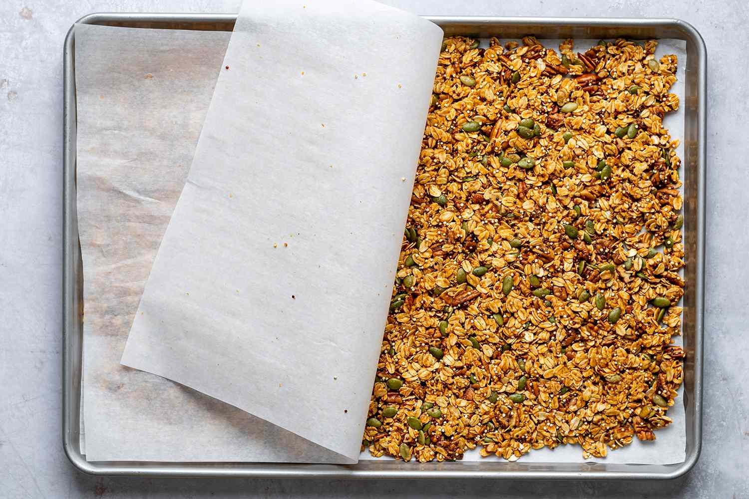 granola on a parchment lined baking sheet