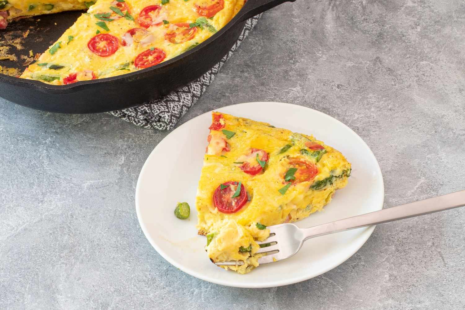 slice of frittata next to the skillet