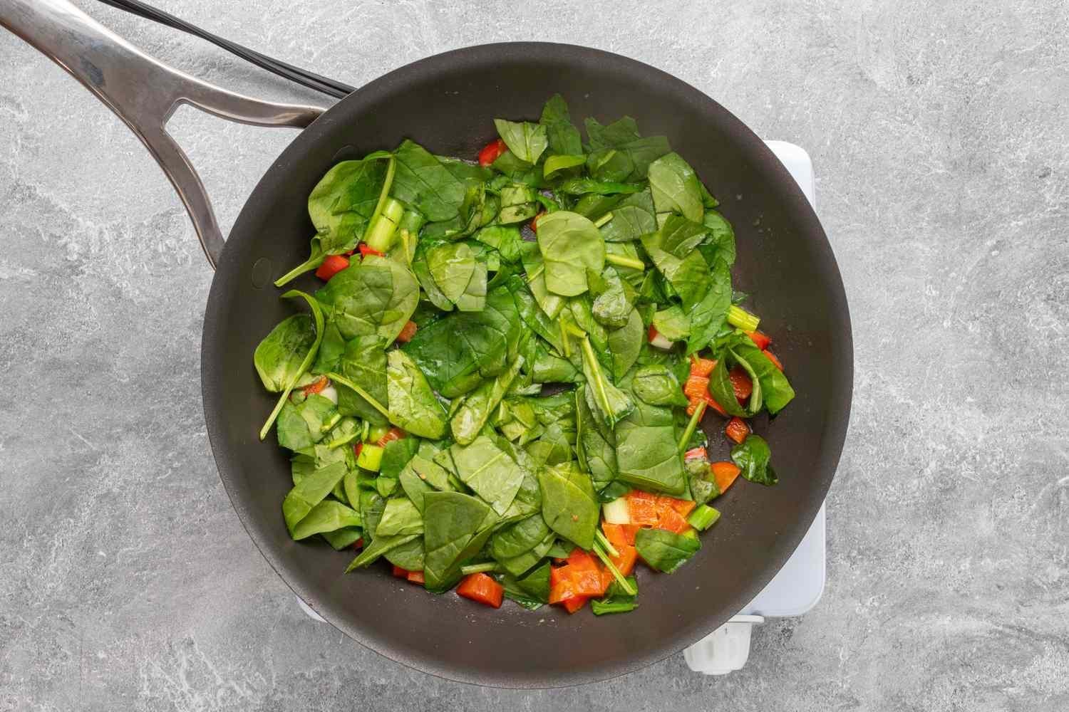 egg white frittata prep: spinach in the skillet