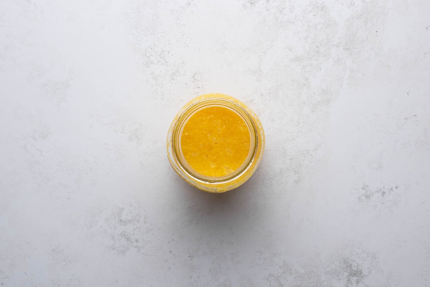 Thickened lemon curd mixture in a container