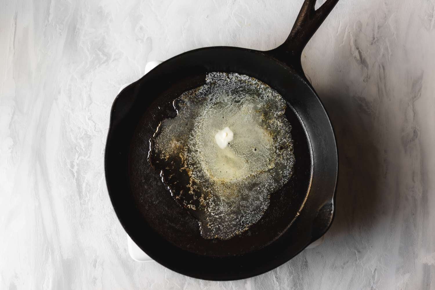 Butter melting in a cast iron skillet