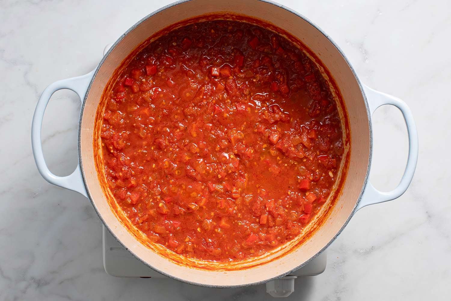 Cooking tomato sauce in a pot