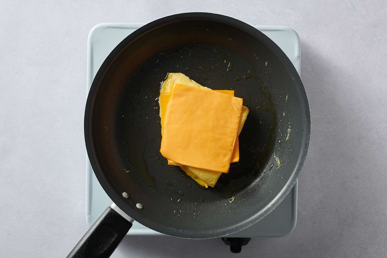 cheese on eggs in skillet