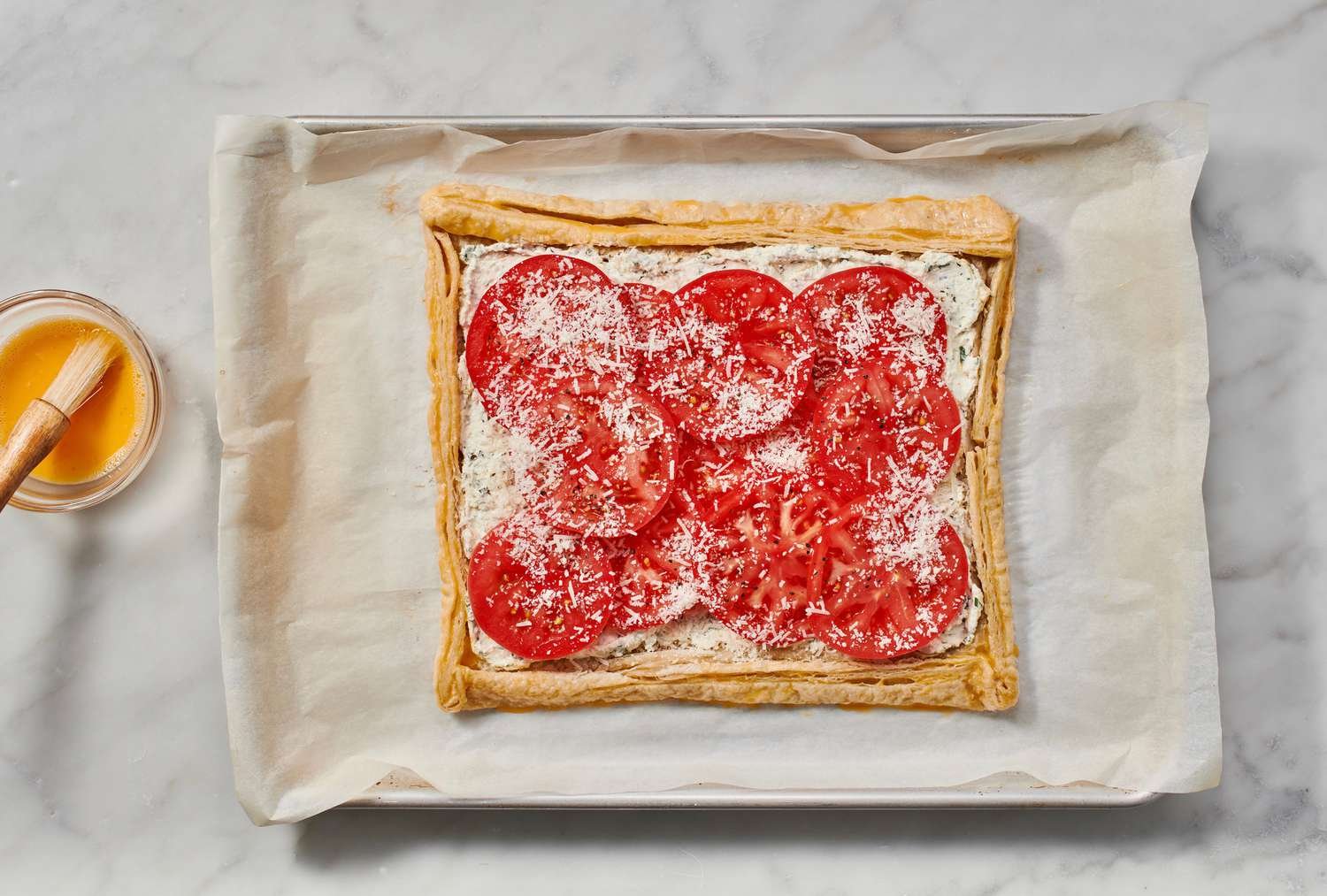 A partially baked puff pastry crust with an egg washed crust border