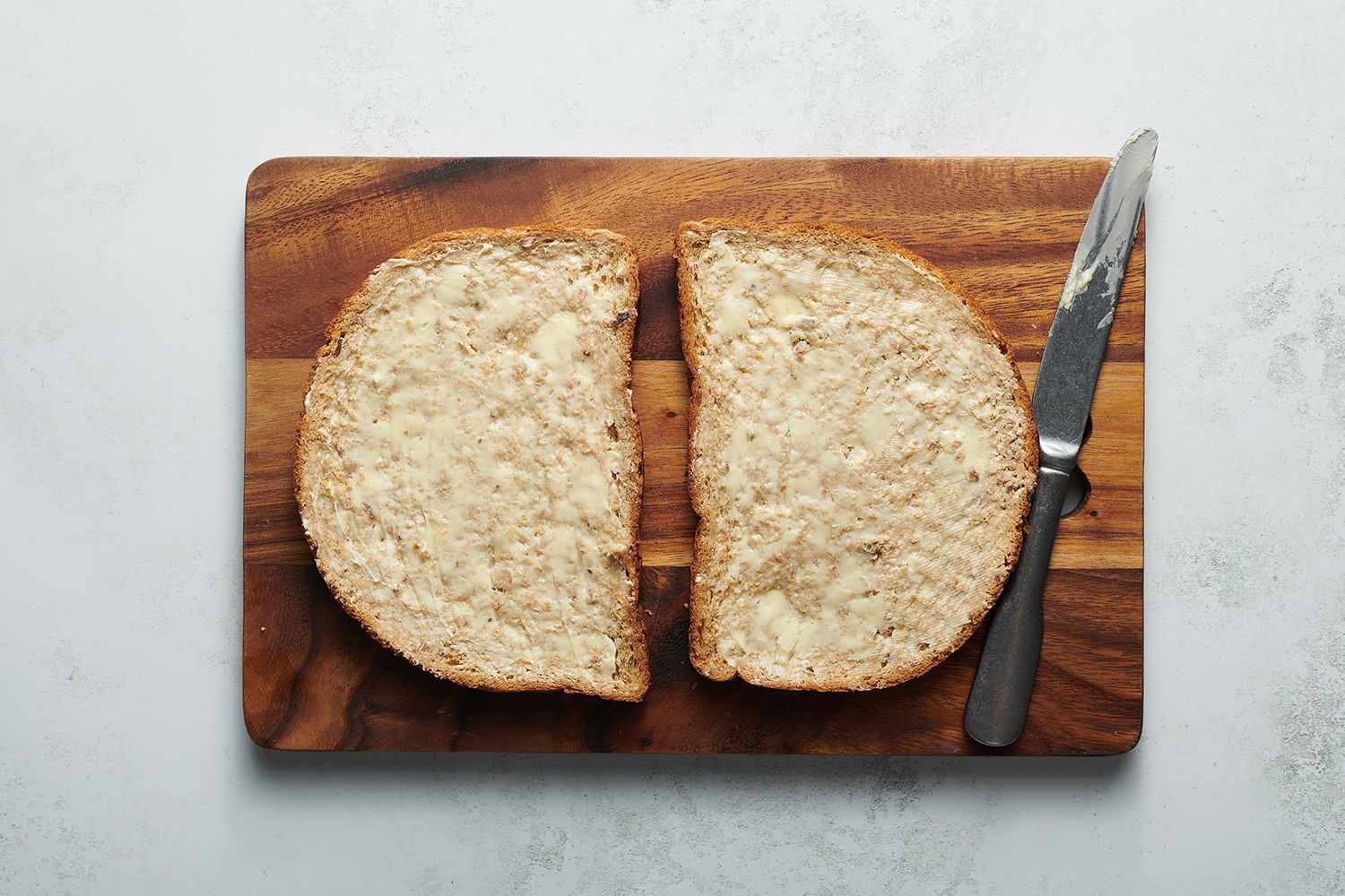 Bread with butter on a cutting board