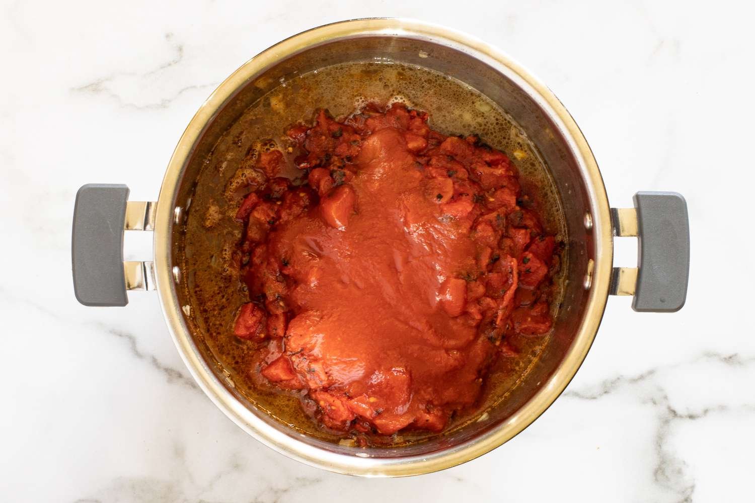 Layered ingredients in the Instant Pot for chili