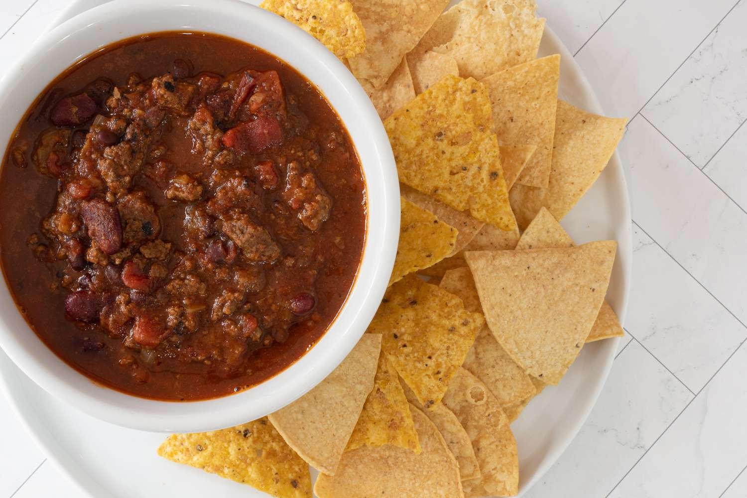 Chili in a bowl with tortilla chips on the side