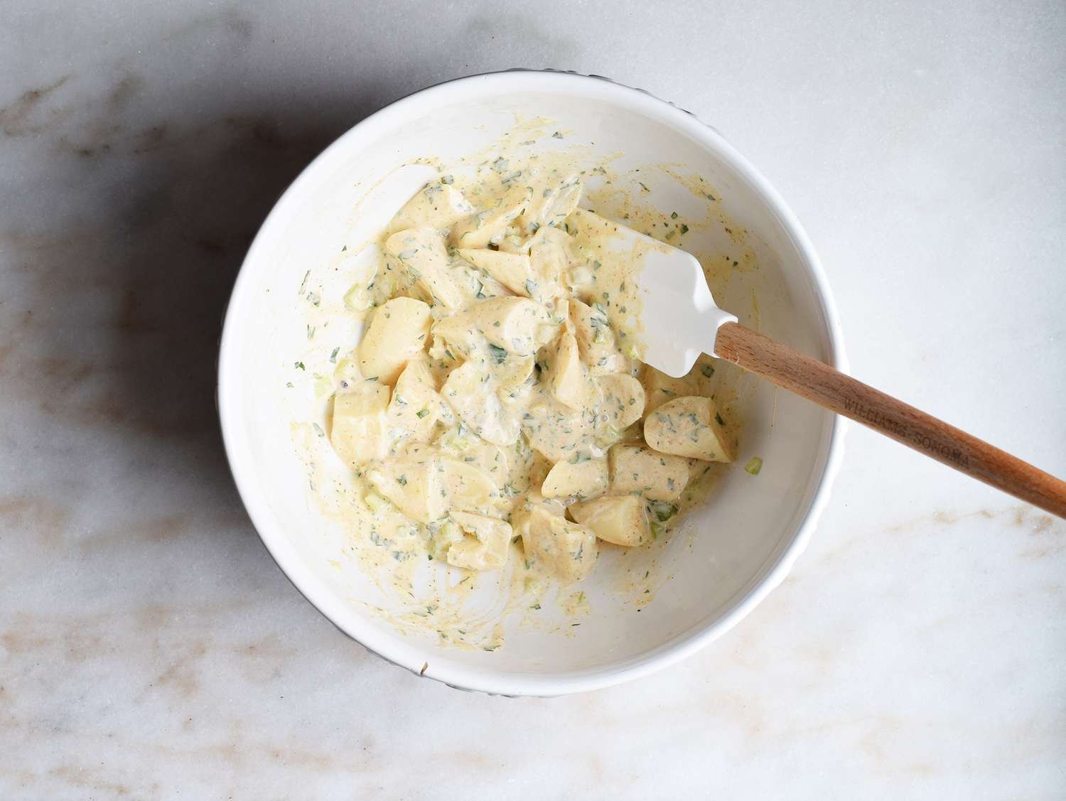 Hearts of palm tossed in mayonnaise dressing in a bowl
